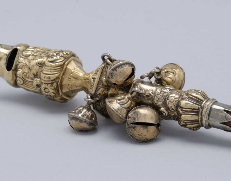 Detail of a rattle with a whistle and a coral handle